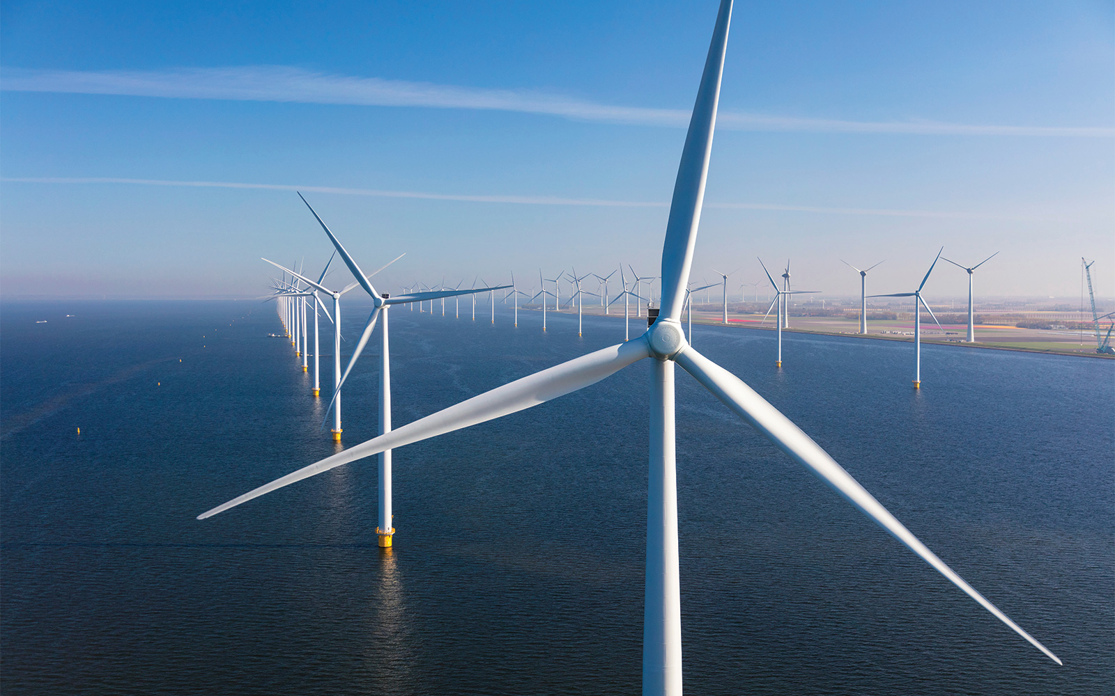 Offshore wind farm - turbines in a row both on and offshore