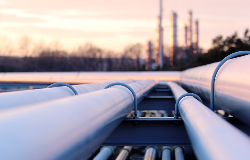 Close up photo of pipelines against dusky sky