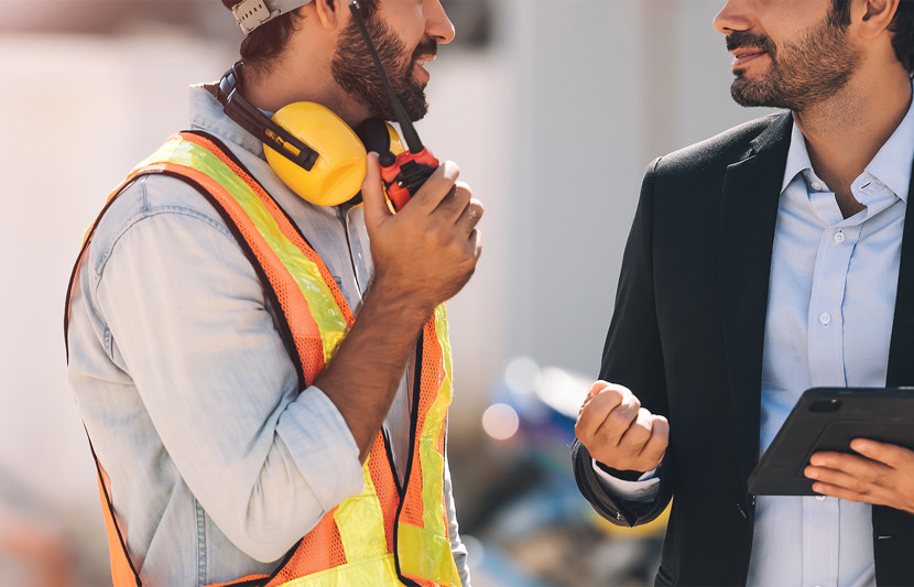 Site staff in hi-vis talking to project manager in suit