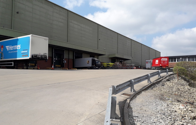 Exterior of logistics warehouse with distribution lorries