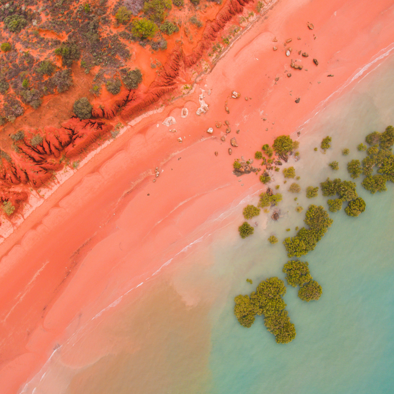 Desert meets the sea - an aerial view of ocean and desert sand dune beach, Broome Western Australia