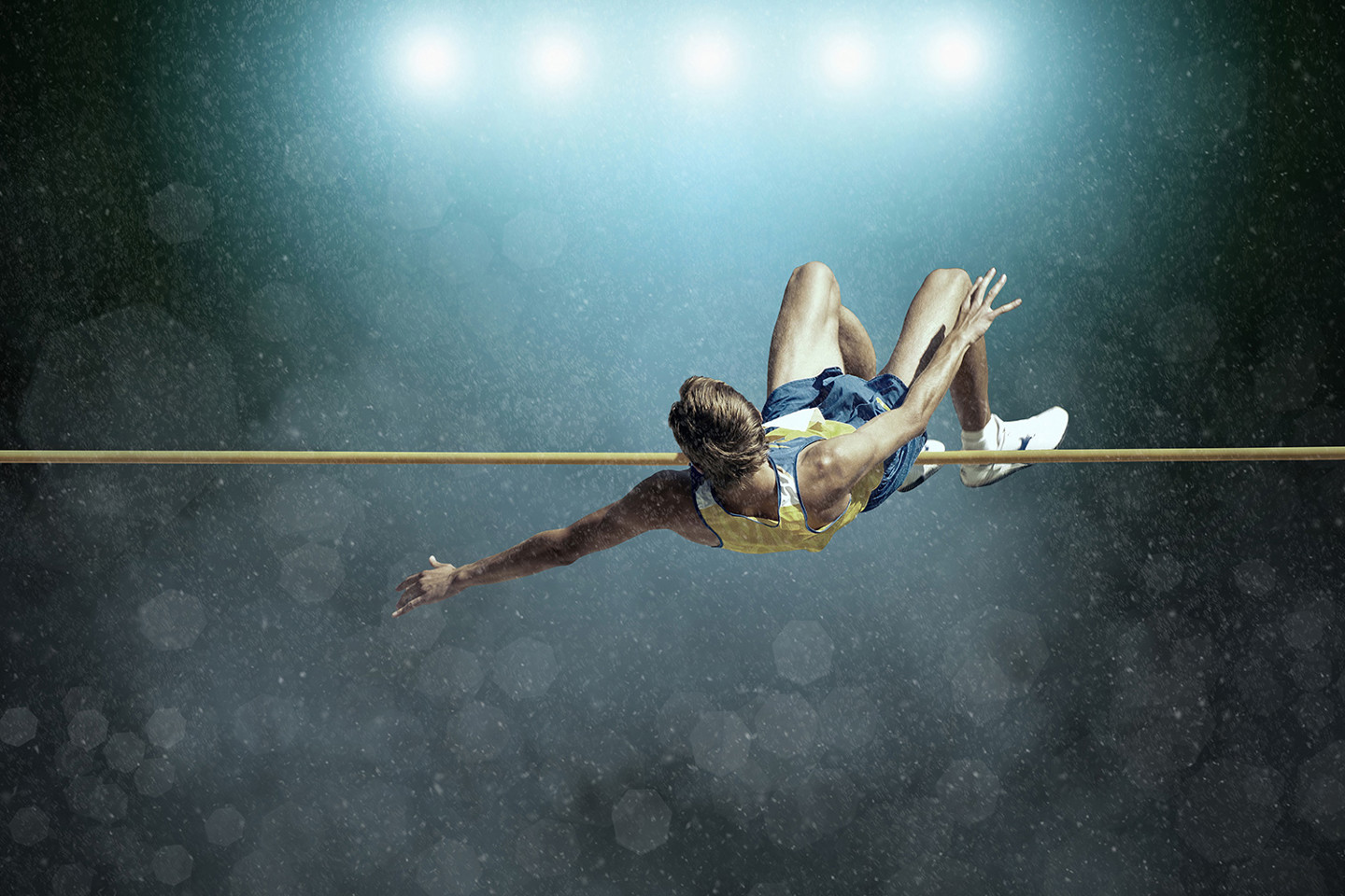 Image of person mid-jump over high jump bar