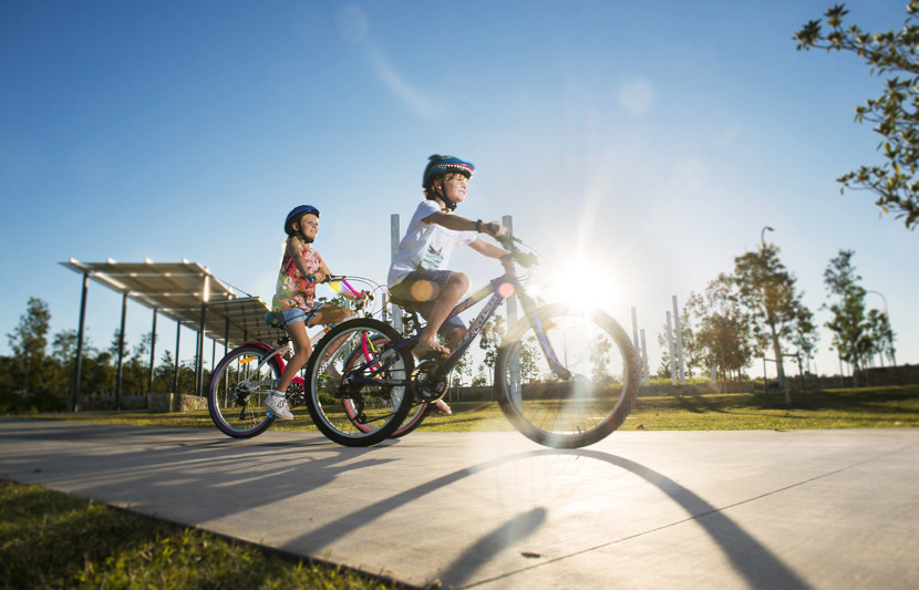 Kids riding their bikes around Yarrabilba, Queensland Australia