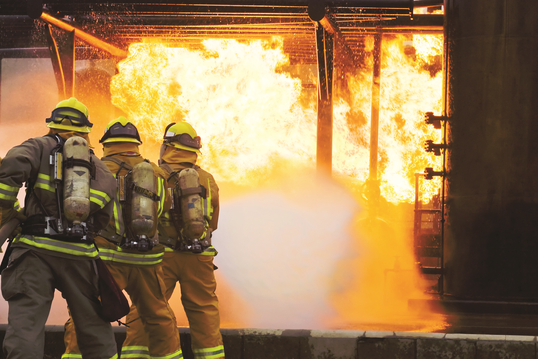 Firefighters putting out flame using new equipment that has transitioned to PFAS-free foam alternatives