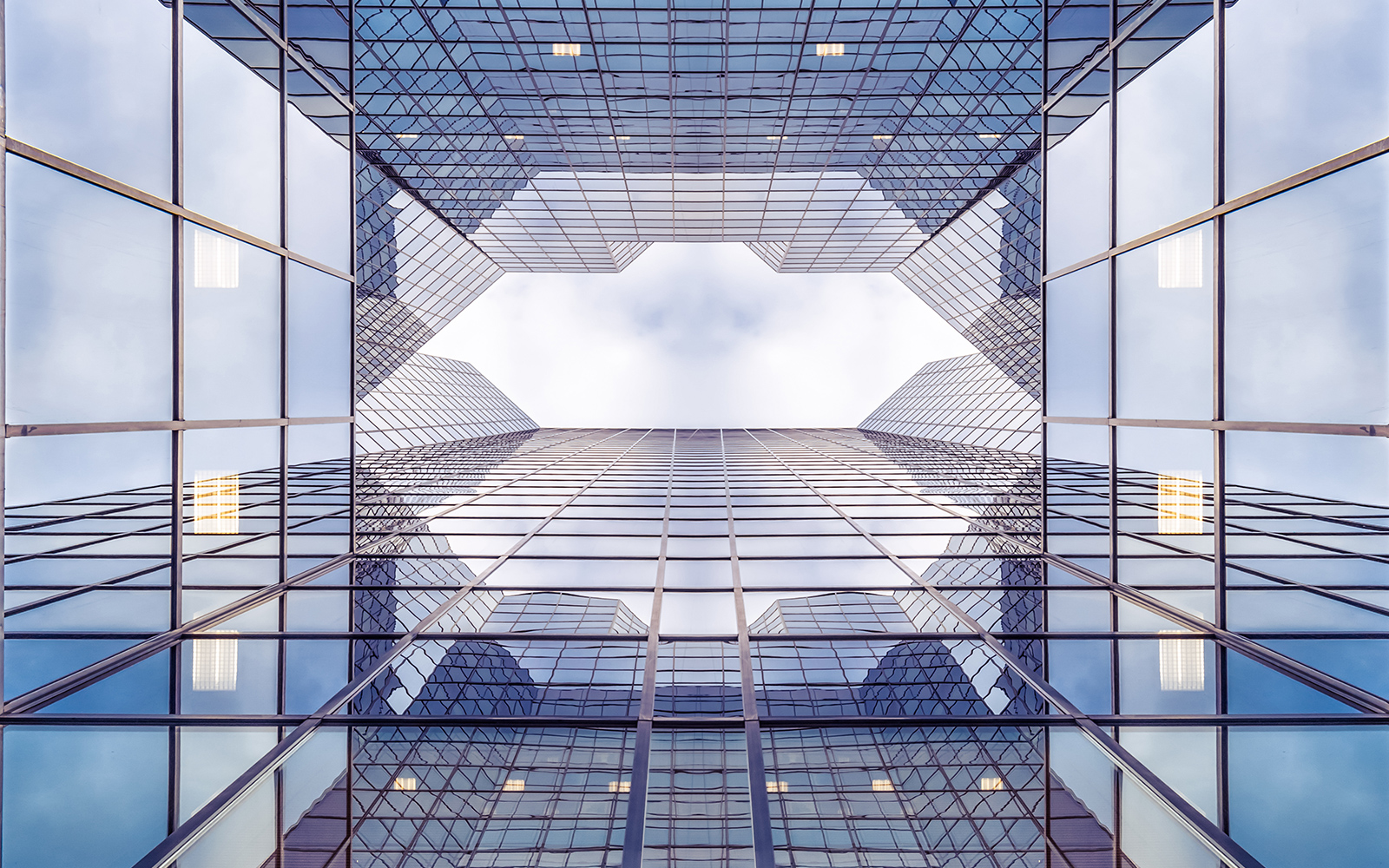 RPS_looking upwards to blue sky from ground level through glass city skyscrapers