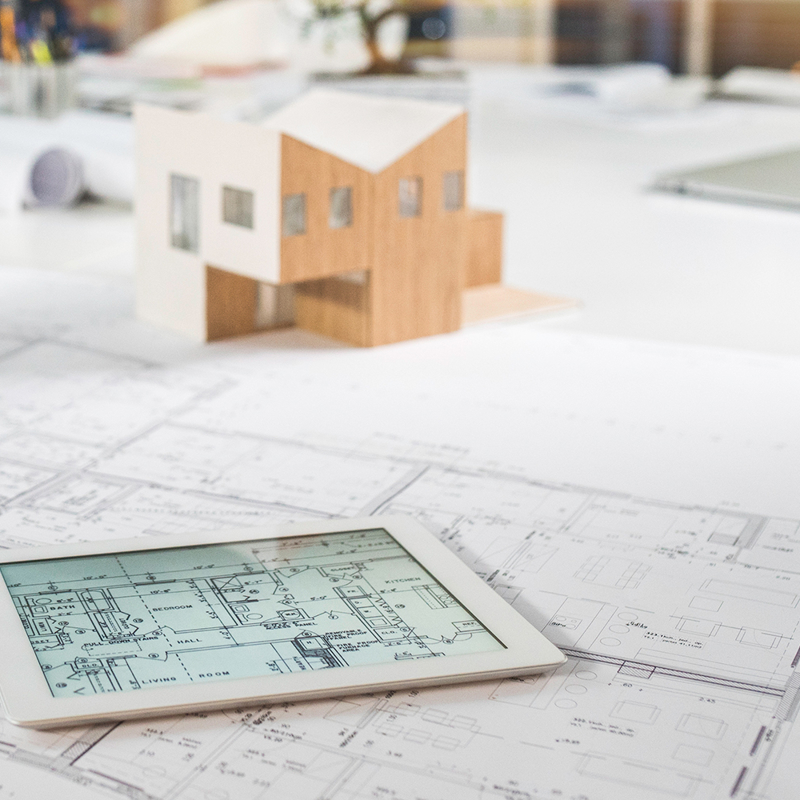 Building designs represented via 3D model, paper schematic and digital plan