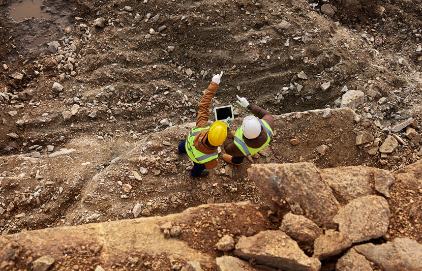 Aerial shot of two people carrying out surveys on the ground