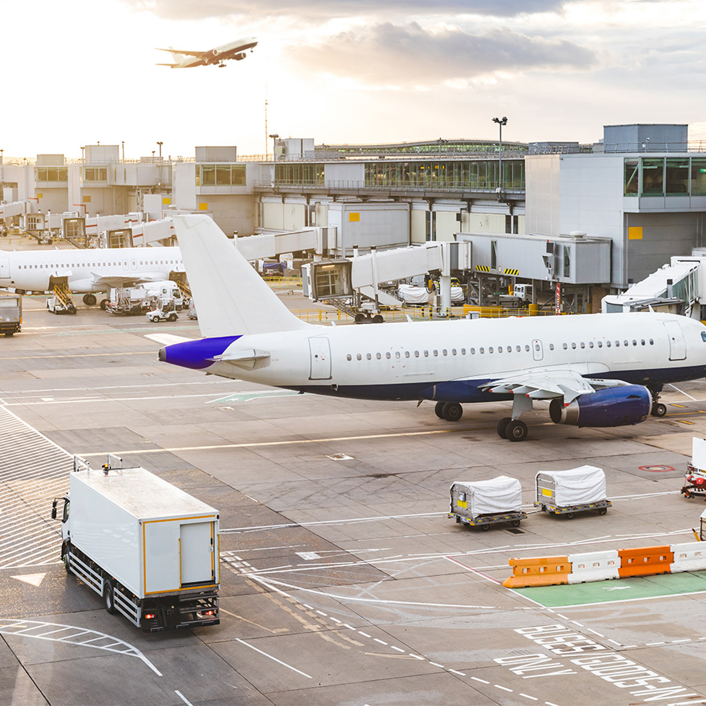 Exterior of an airport terminal with planes and cargo