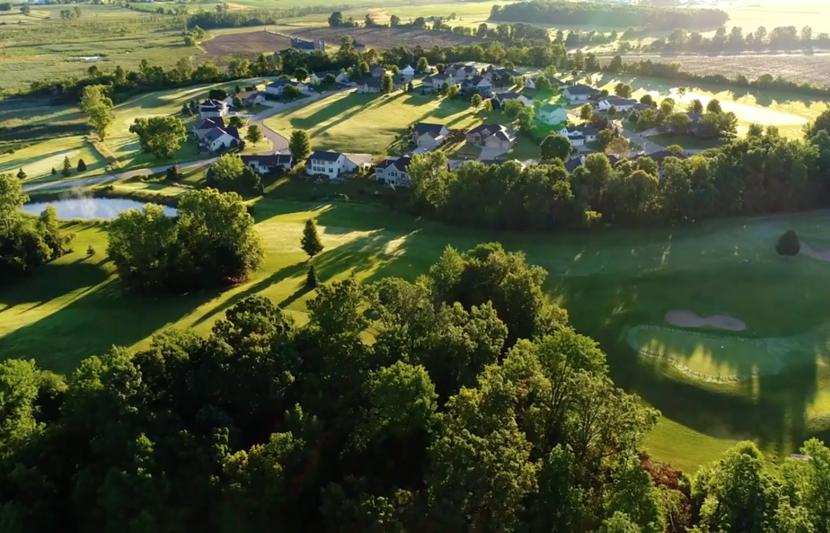 Aerial landscape with housing development surrounded by fields