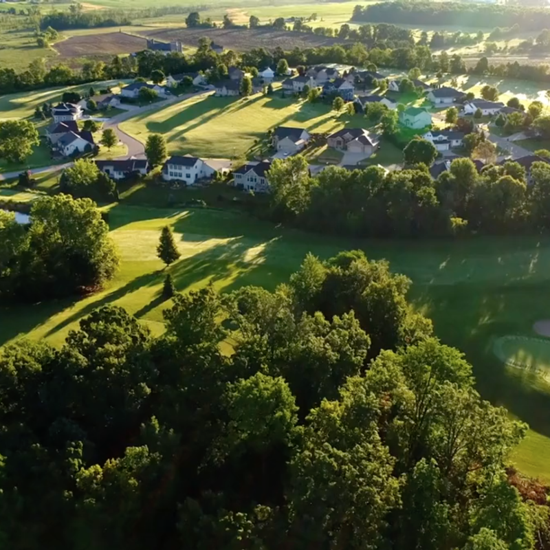 Environment landscape with small housing development, pond and golf course 