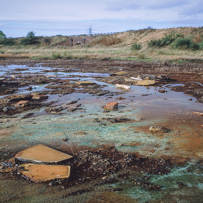 Contaminated site filled with water and debris