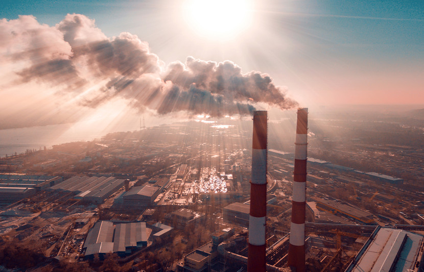 Plant emitting smoke on a backdrop of blue sky and sunshine