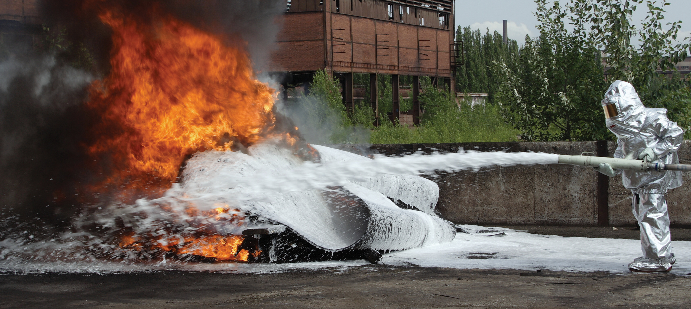 An image of a firefighter extinguishing a blaze. PFAS & PFOS are chemicals given off.  