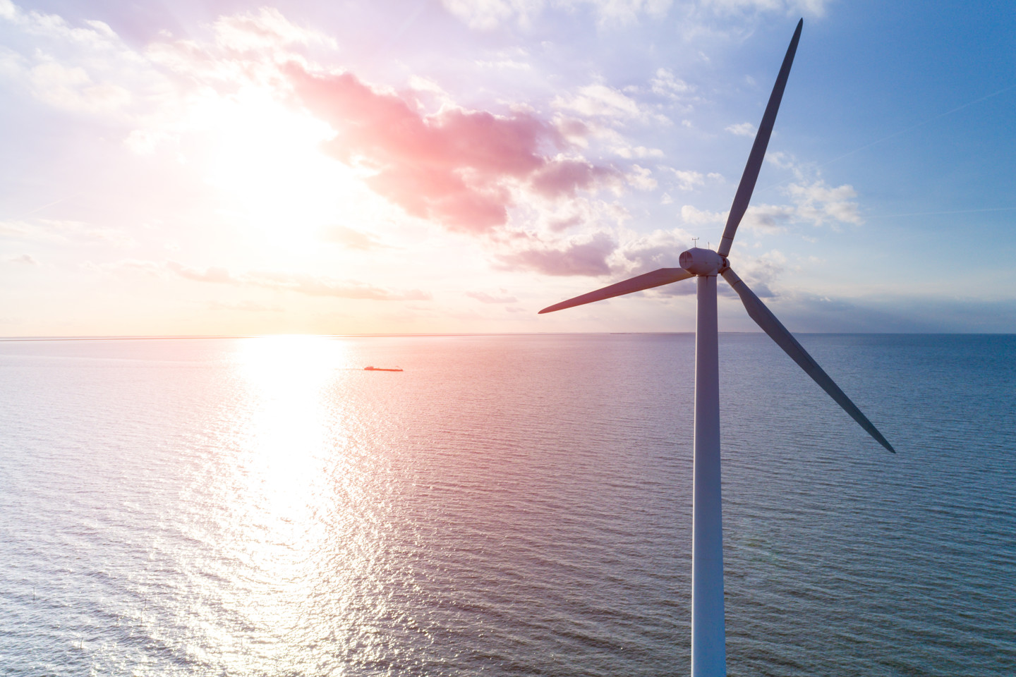 Renewable energy wind turbine at sunset