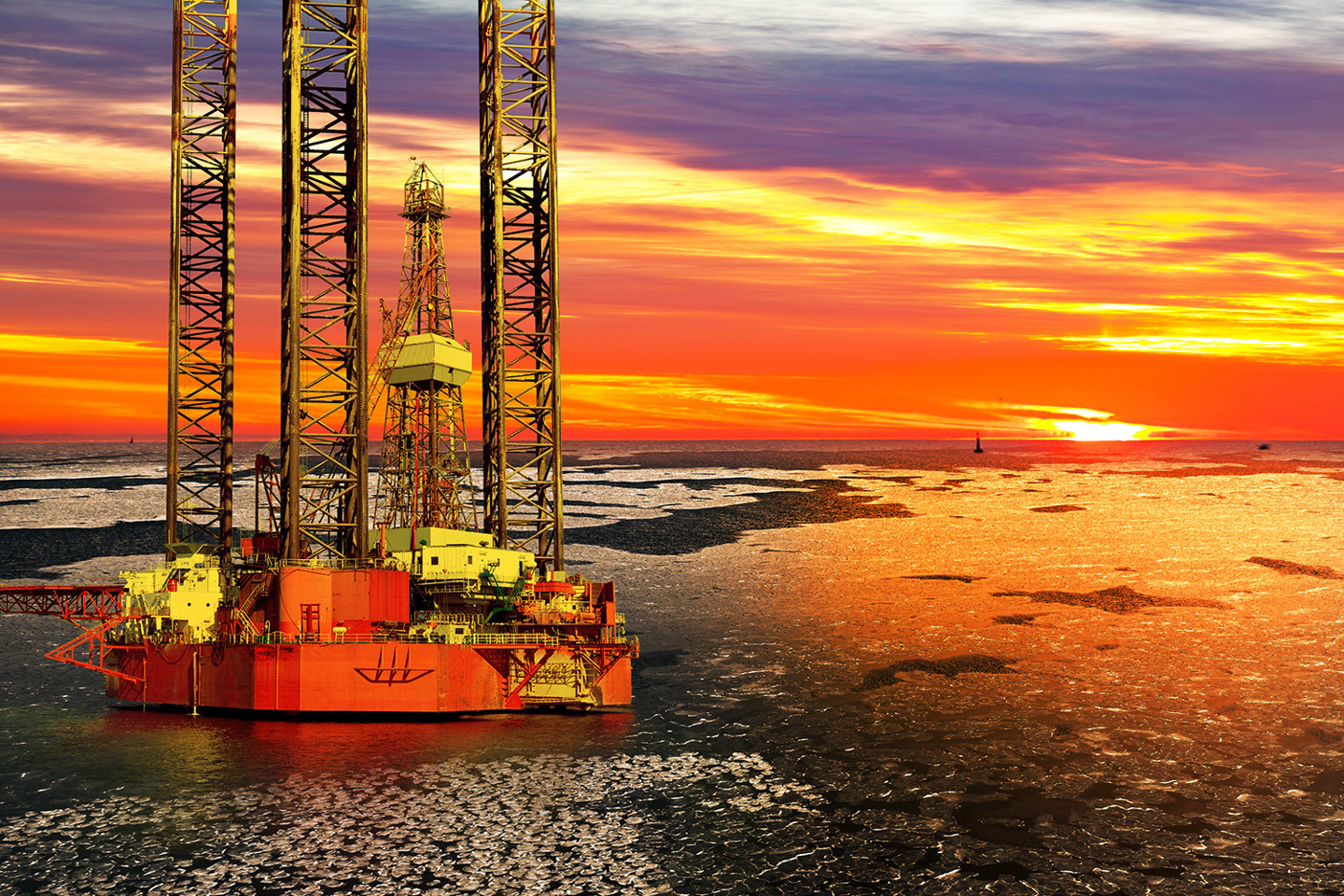 Offshore rig at sunset on frozen waters