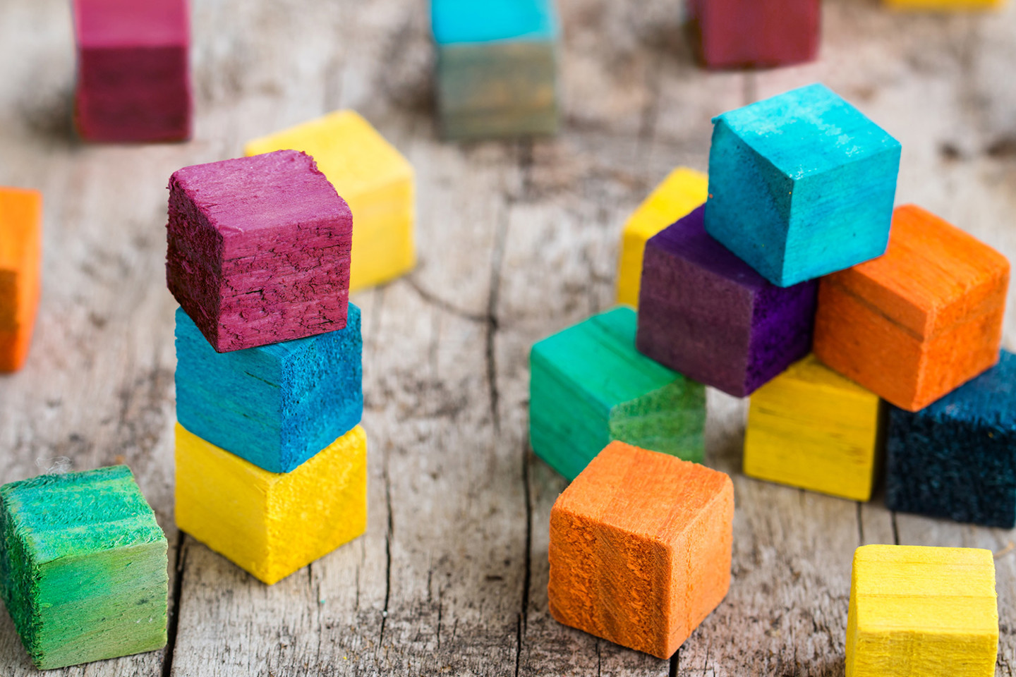Wooden stacked coloured blocks building blocks representing fast tracked infrastructure