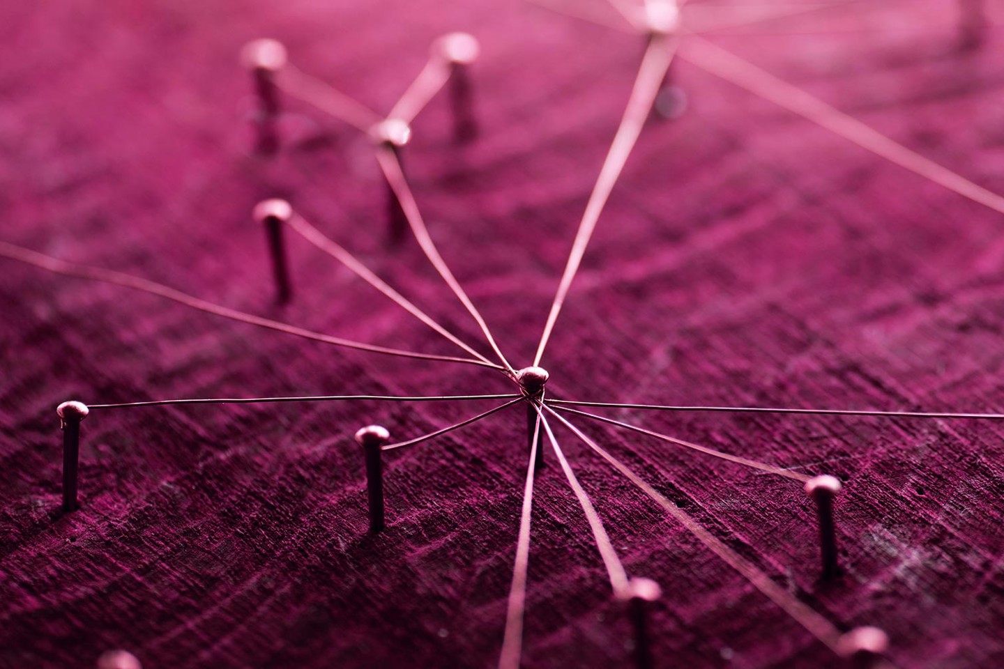 Pins in plum coloured board representing a network for fast tracked infrastructure