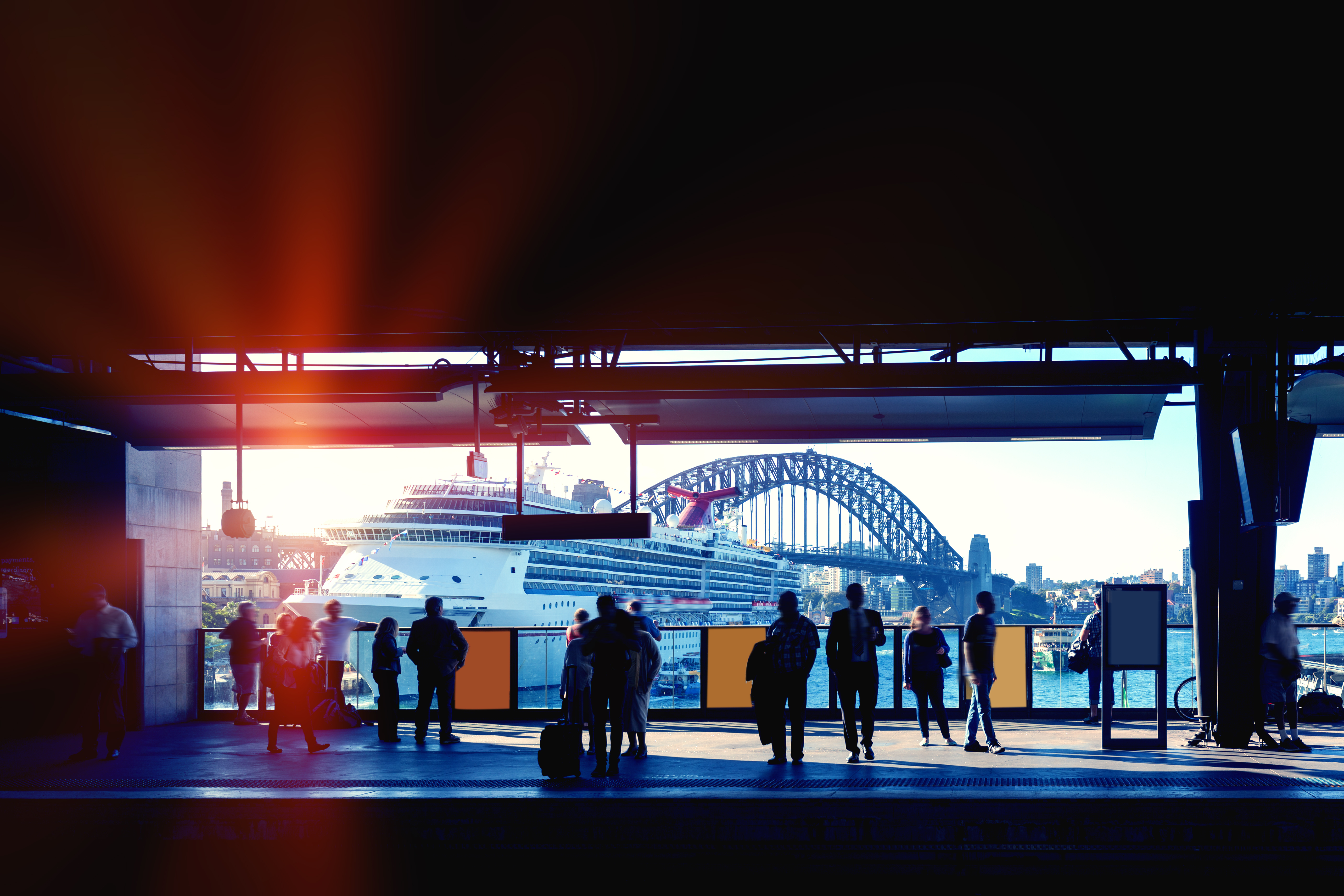 Sydney Circular Key Station with commuters waiting for train and cruise ship and Sydney Harbour Bridge in the background.