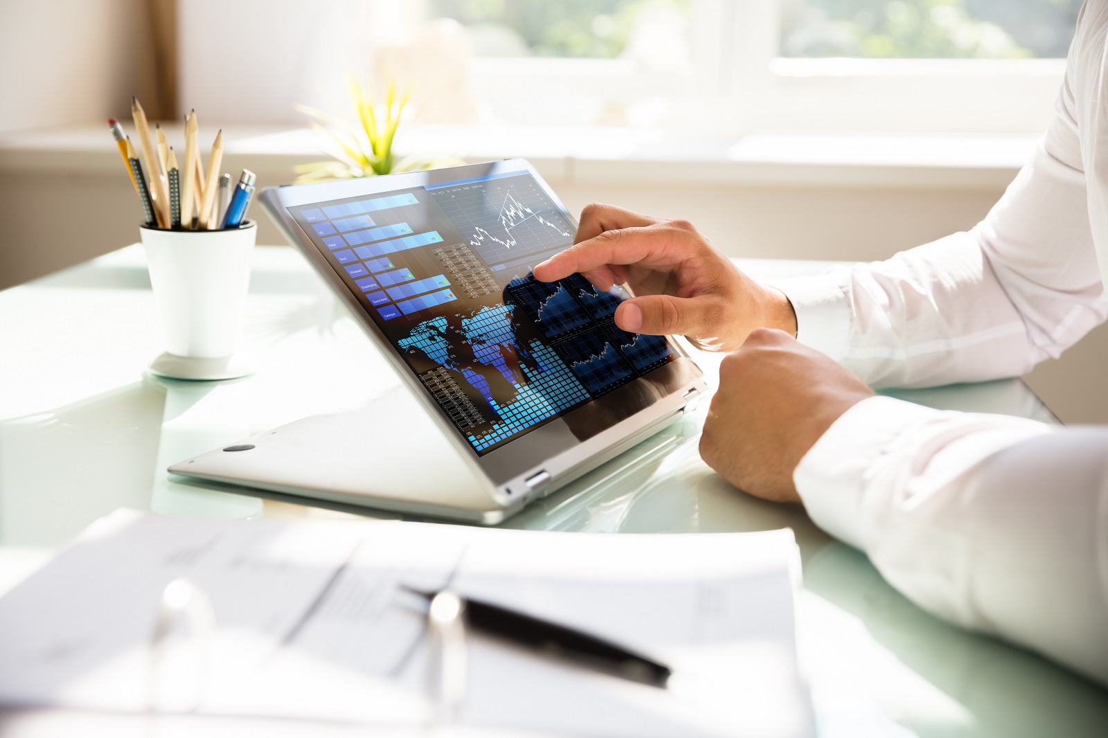 Person using dashboard interface to analyse complex data on a surface computer