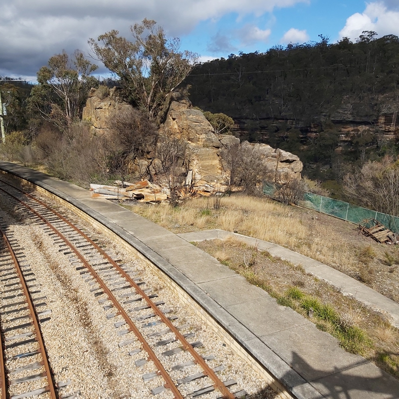 Railway line with burnt bush