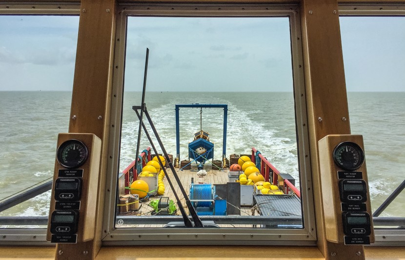 A view from the iside of a boat looking out to sea.