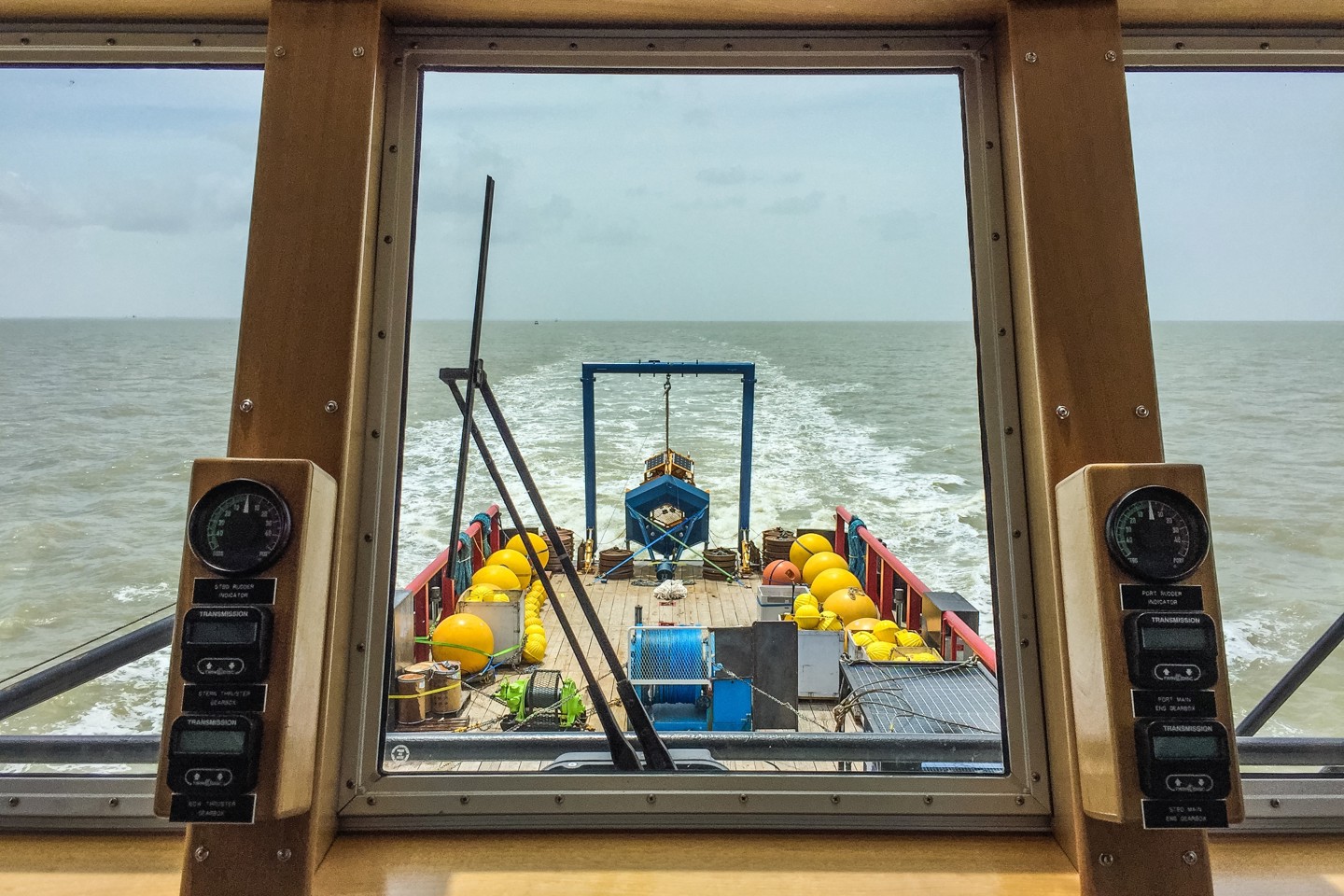 A view from the iside of a boat looking out to sea.