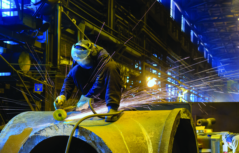 worker in factory with power tools
