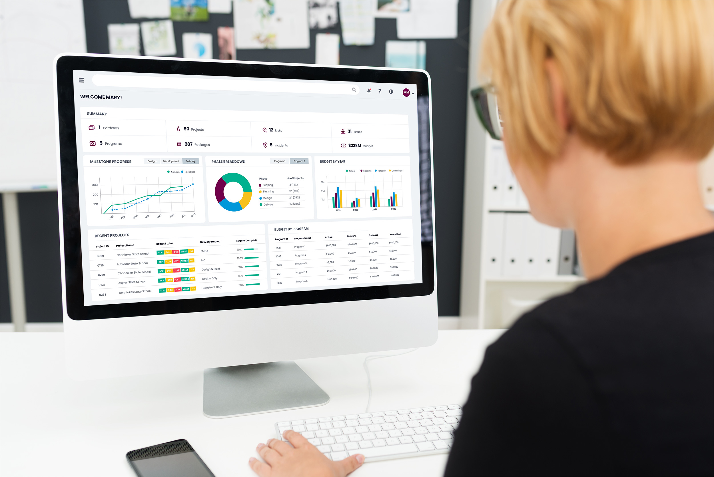 Woman using myProjects software and looking at project dashboard on computer