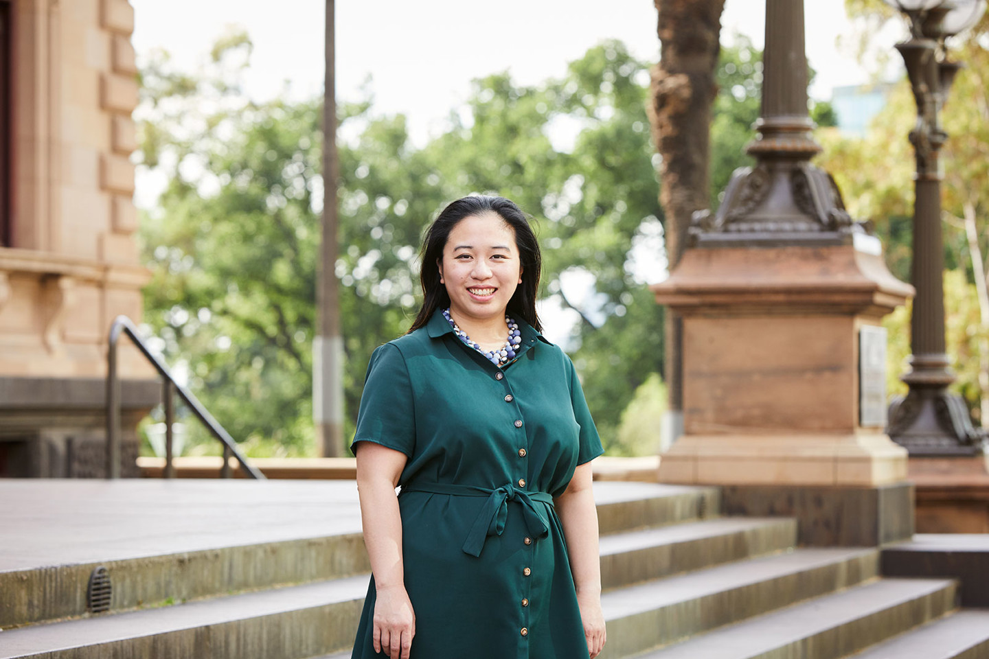 Georgina Leahy, RPS Associate Director is standing outside on the steps of The Old Treasury Building in Melbourne CBD.