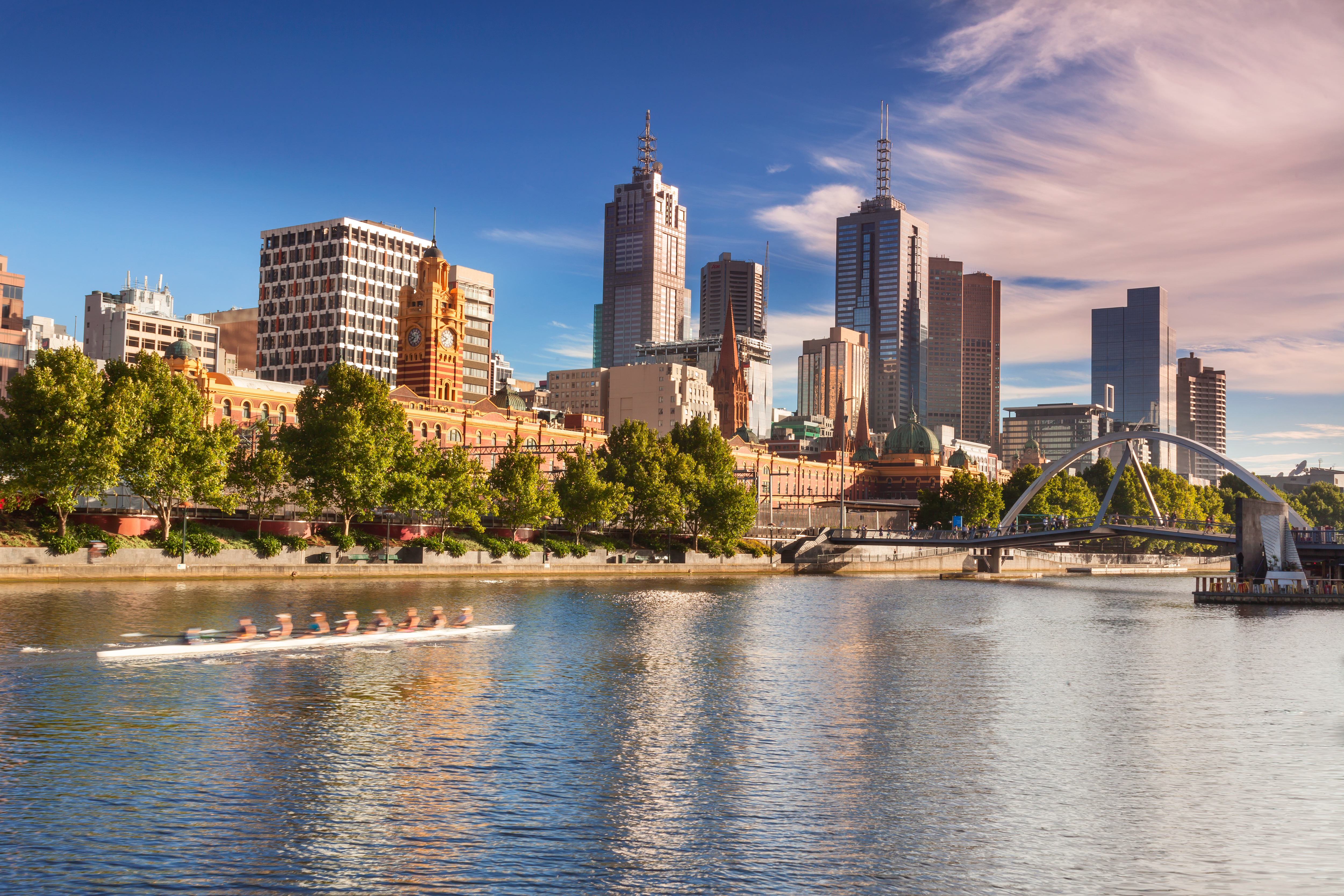 Looking across the Yarra River from Southbank with early morning rowers training, Melbourne.
