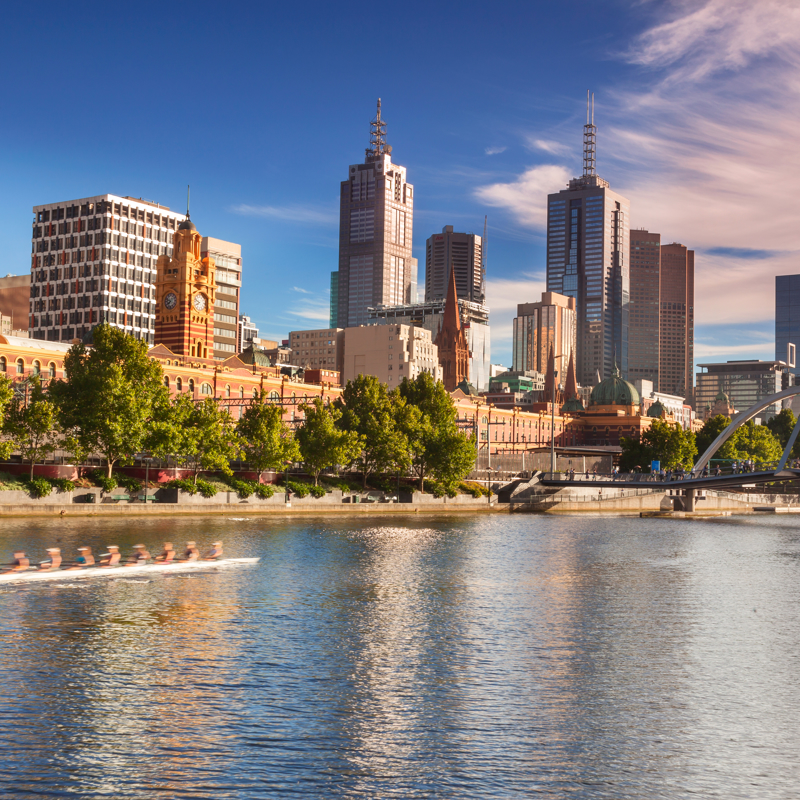 Looking across the Yarra River from Southbank with early morning rowers training, Melbourne.