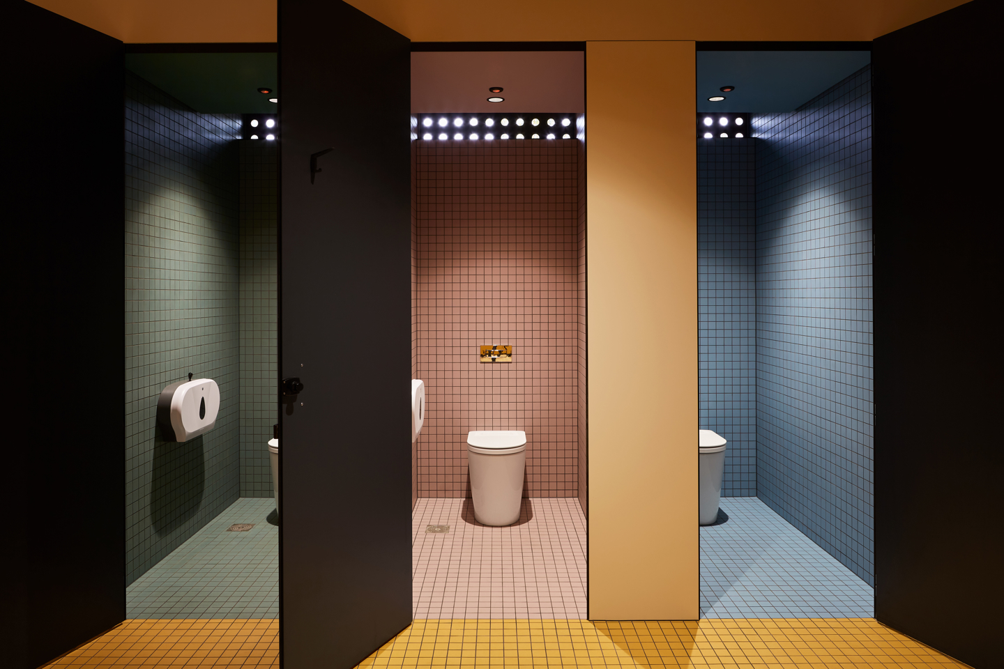 Hayman Theatre all-gender bathroom facilities with green red orange and blue tiles