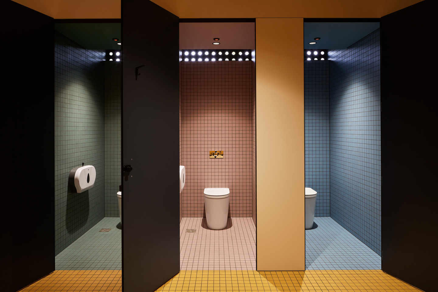 Hayman Theatre all-gender bathroom facilities with green red orange and blue tiles