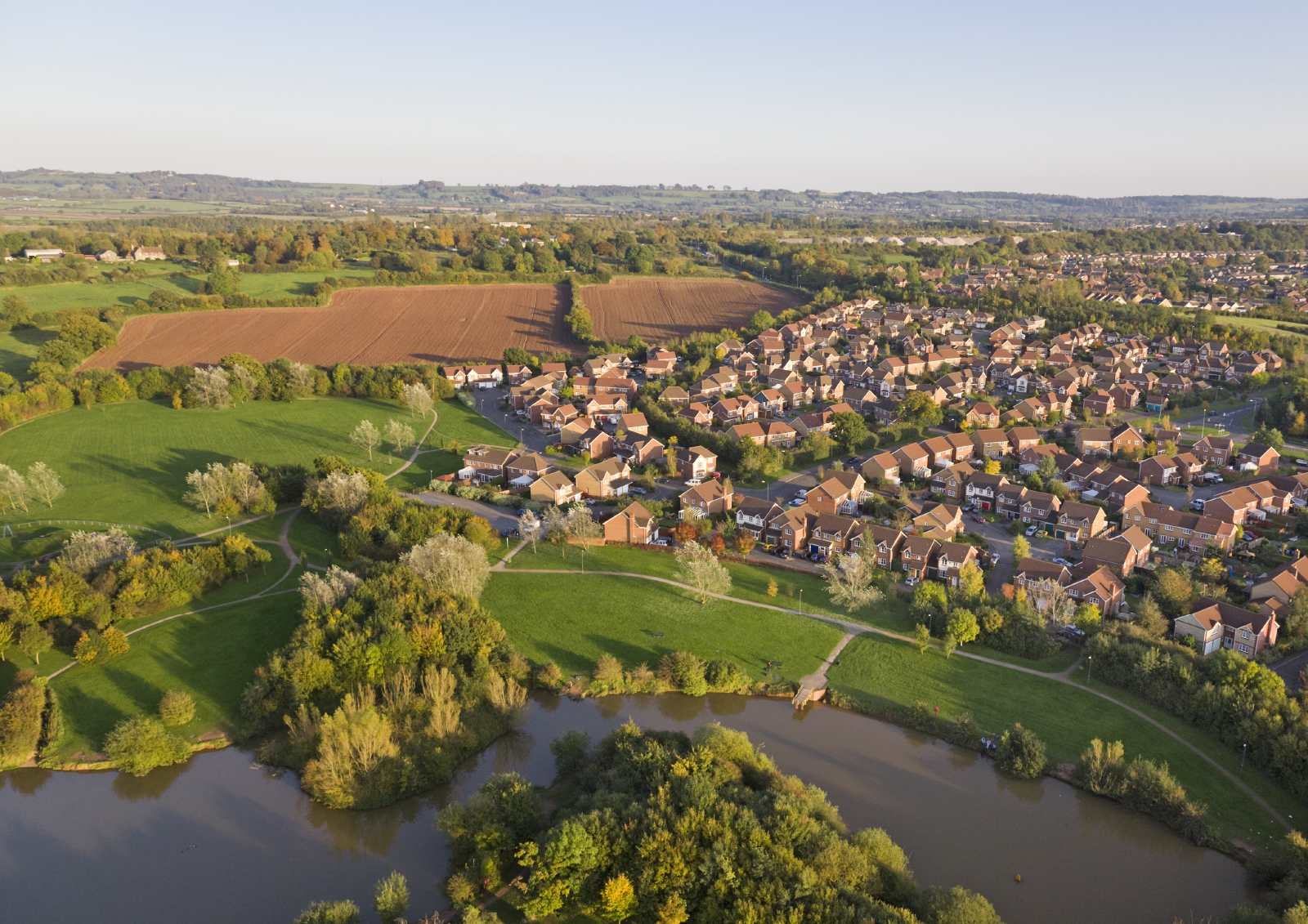 An aerial view of houses and countryside with a river running through