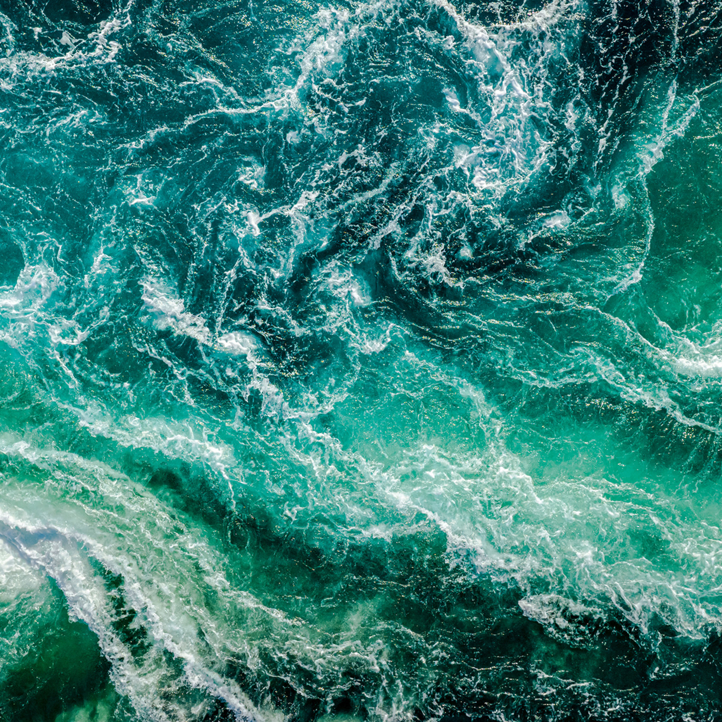 Aerial shot of waves crashing in the sea