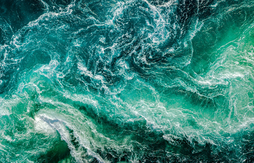 Aerial shot of waves crashing in the sea