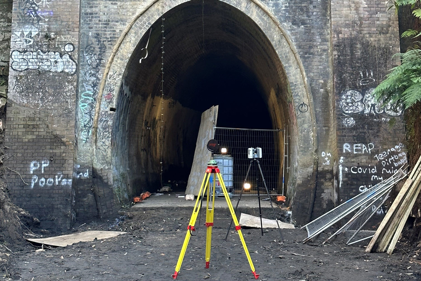 Outside the Lapstone Hill Tunnel, which shows signs of graffiti - and surveying equipment perched on entry.  