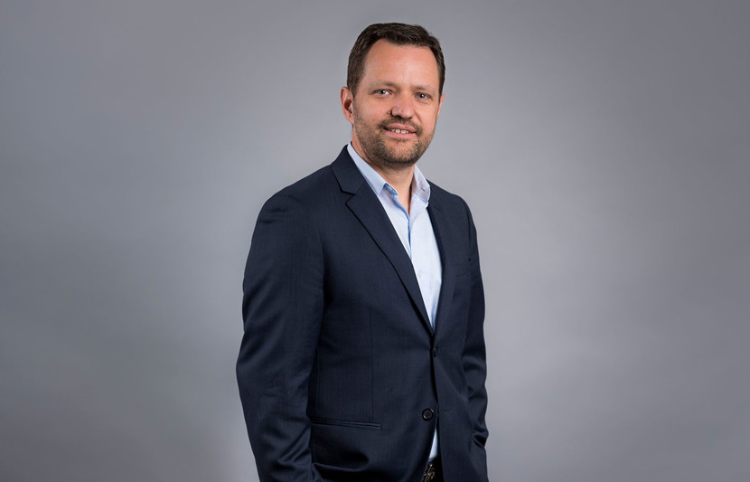Eldon Davison, Executive Project Director, RPS, Sydney, New South Wales, Australia stands in a grey suit smiling 