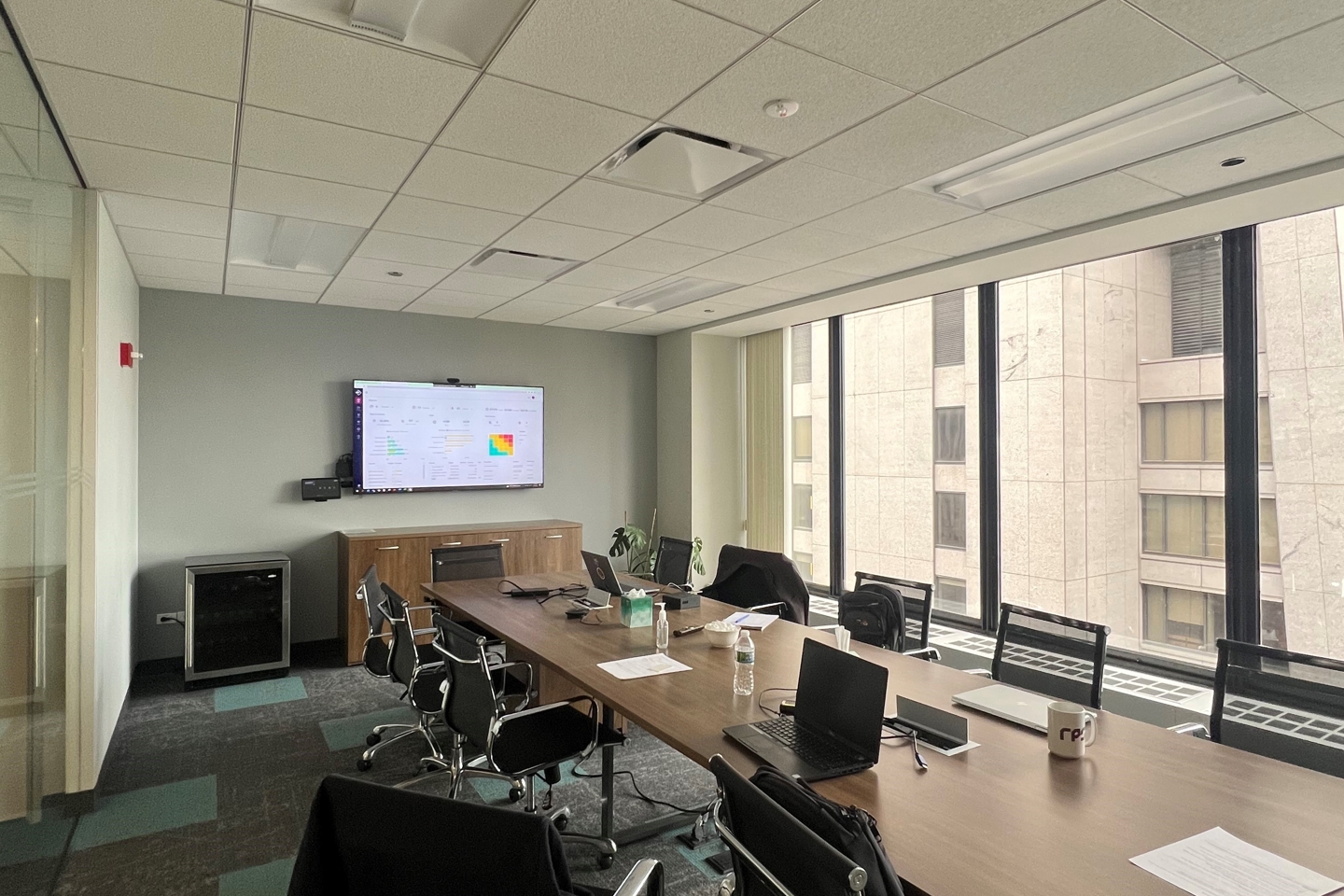 An empty board room with a screen at the end showcasing the myProjects software solution capability