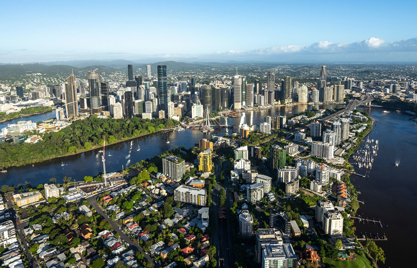 Aerial view of Brisbane River and city from Kangaroo Point, with Story Bridge and new green bridge construction. Sunny day.