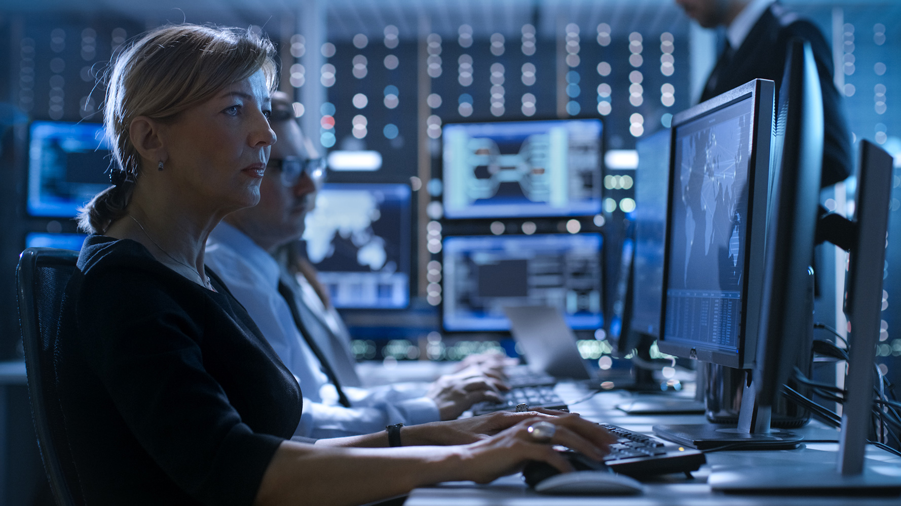 Defence sector expertise RPS 
Image: Defence Intelligence Analysts working on computers in secure facility. Blue lights from multiple display screens showing various intelligence sources.