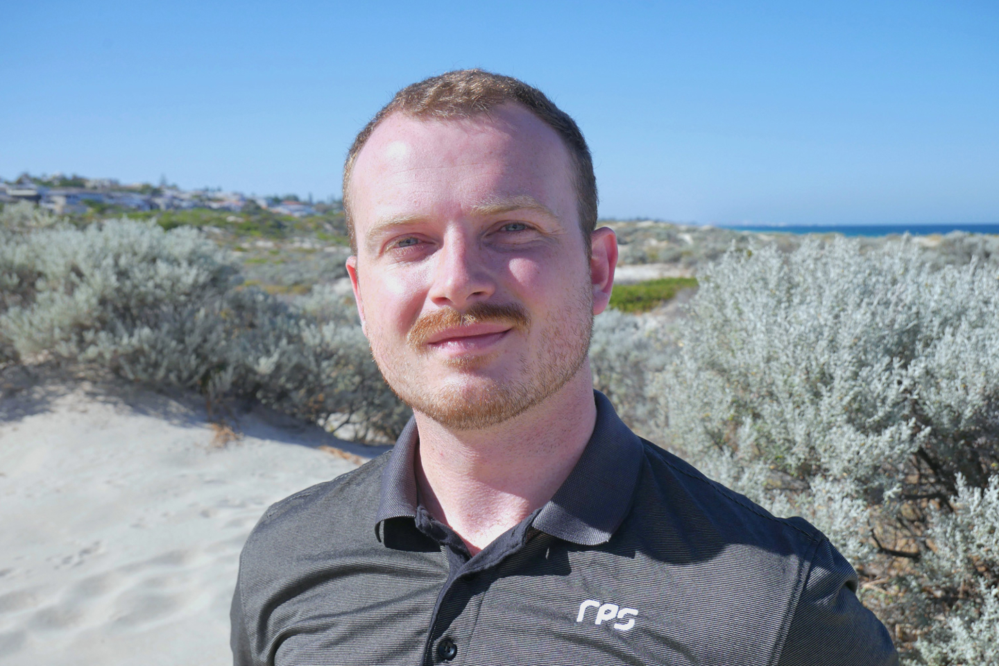 RPS Scientist Ciaran Carolan soaks up the sun at his local beach in Scarborough, Perth