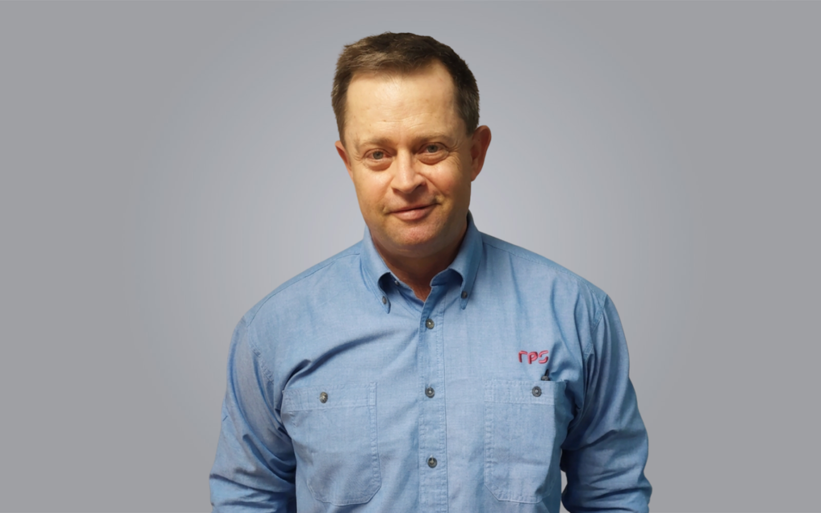 Fletcher Magill, Senior Principal and Practice Lead - Survey, Cairns.

Image: Fletcher smiles at the camera wearing blue chambray shirt.
