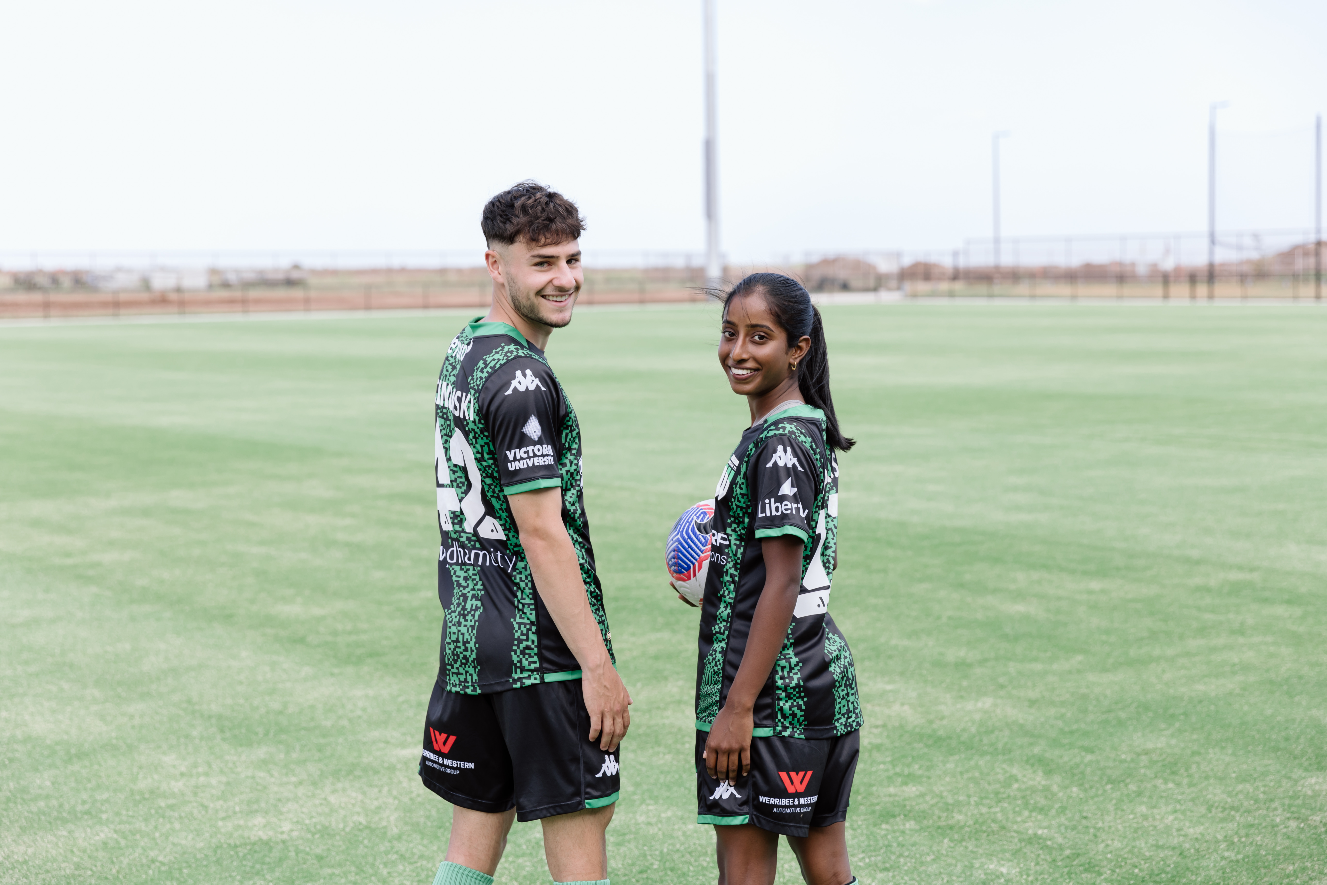 Football players smile at camera on new field at the Regional Football Facility in Tarneit, VIC, Project management by RPS. Image courtesy of Wyndham City Council.